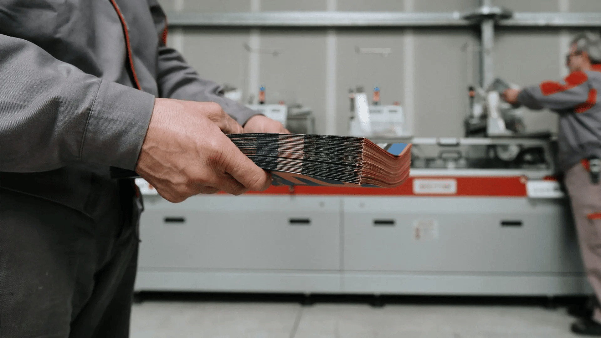 Man Holding a Bundle of Brochures