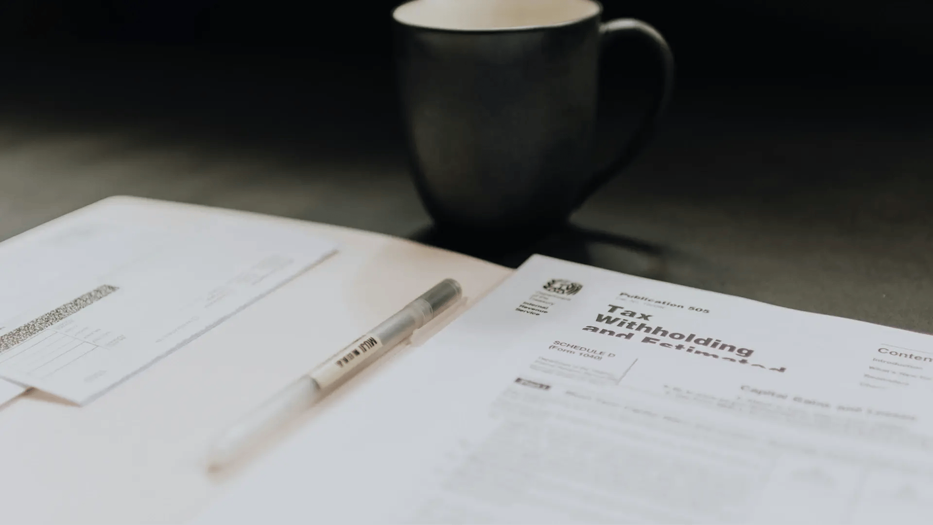 Tax Papers on a Table with a Ink Pen